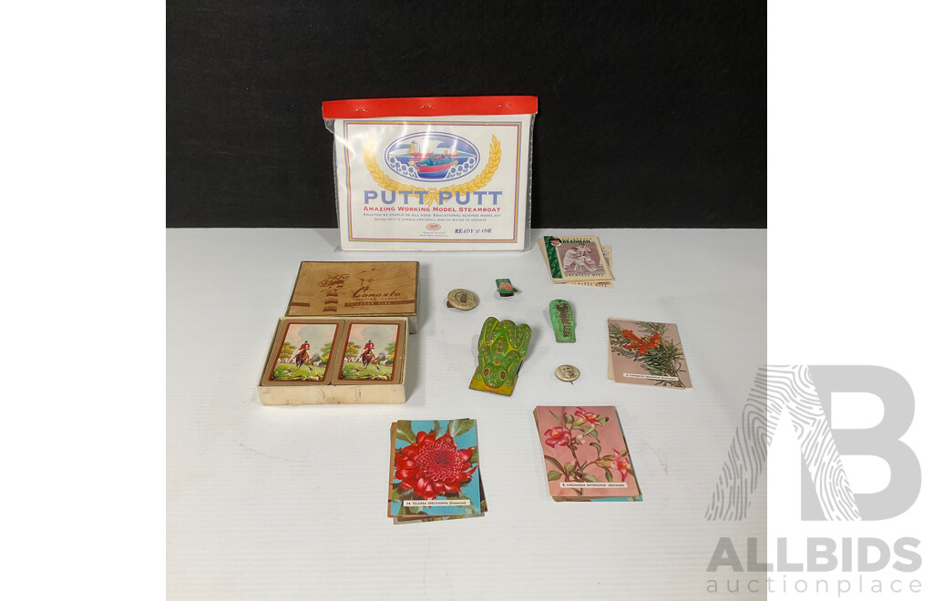Vintage Tin Toy Clickers Including Two West German Examples, Marmite, Hutton's Pineapple Brand, Hudson Industries Canasta Playing Cards, Putt Putt Boat in Sealed Pack, Bradman Playing Cards, Wildflowers of Australia Cards