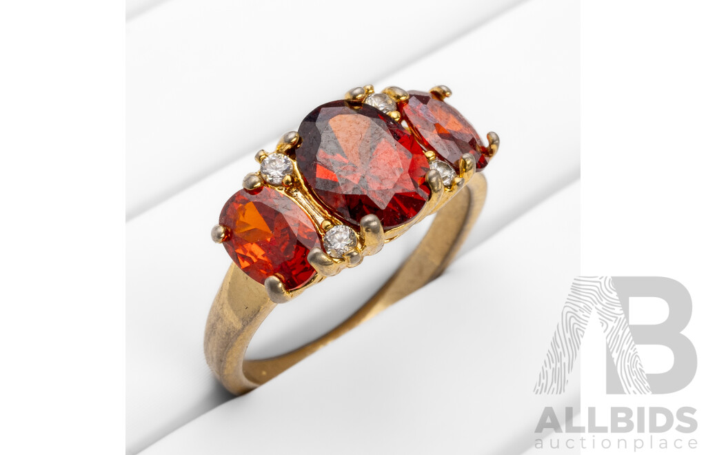 Gold Plated Unstamped Ring with 3x Synthetic Oval Orange Garnets and 4x Cubic Zirconias