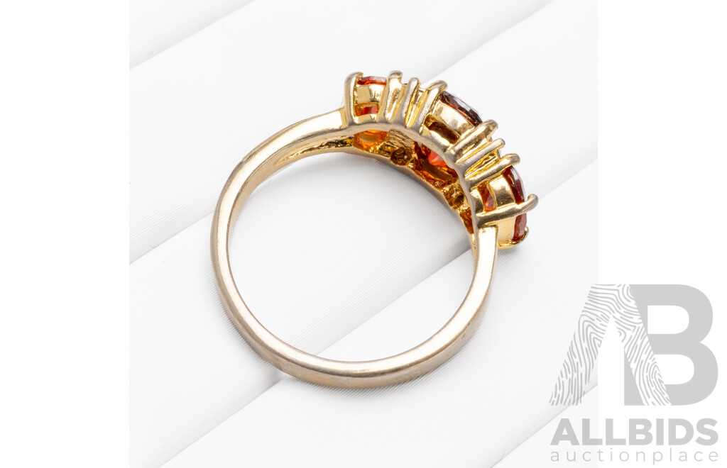 Gold Plated Unstamped Ring with 3x Synthetic Oval Orange Garnets and 4x Cubic Zirconias