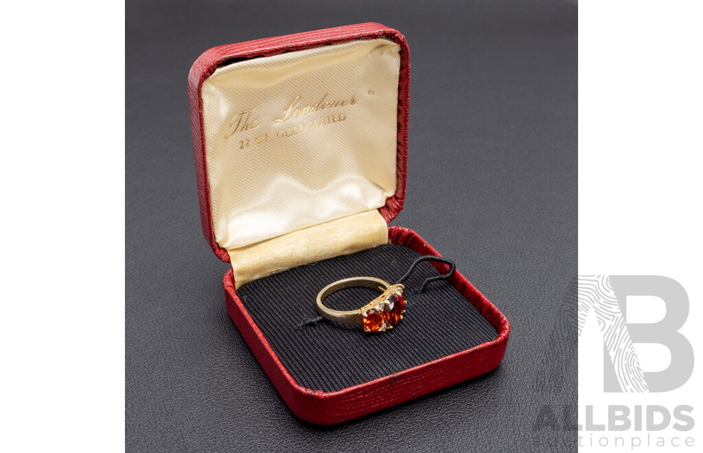 Gold Plated Unstamped Ring with 3x Synthetic Oval Orange Garnets and 4x Cubic Zirconias
