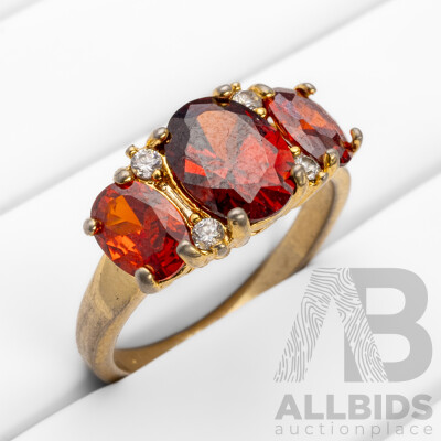 Gold Plated Unstamped Ring with 3x Synthetic Oval Orange Garnets and 4x Cubic Zirconias