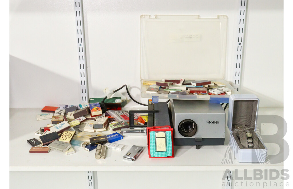 Vintage Cigarette Lighters Including Ronson Battery Powered, Imco Triplex Kerosene, Zippo Scrimshaw, DKNY Women's Watch with Box, Vintage Matchbox Collection Including Qantas and Life Be in It, Rollei Projector