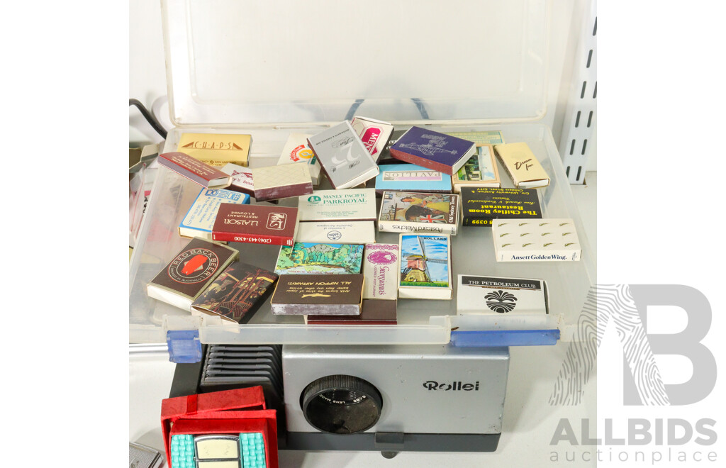 Vintage Cigarette Lighters Including Ronson Battery Powered, Imco Triplex Kerosene, Zippo Scrimshaw, DKNY Women's Watch with Box, Vintage Matchbox Collection Including Qantas and Life Be in It, Rollei Projector