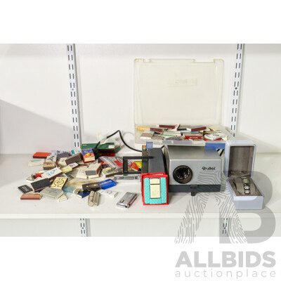 Vintage Cigarette Lighters Including Ronson Battery Powered, Imco Triplex Kerosene, Zippo Scrimshaw, DKNY Women's Watch with Box, Vintage Matchbox Collection Including Qantas and Life Be in It, Rollei Projector