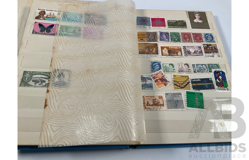 Two Albums of Vintage International Stamps Including Australian Predecimal, Canada, Great Britain, Philippines, Fiji, USA, Poland, Germany, New Zealand, Papua New Guinea and More