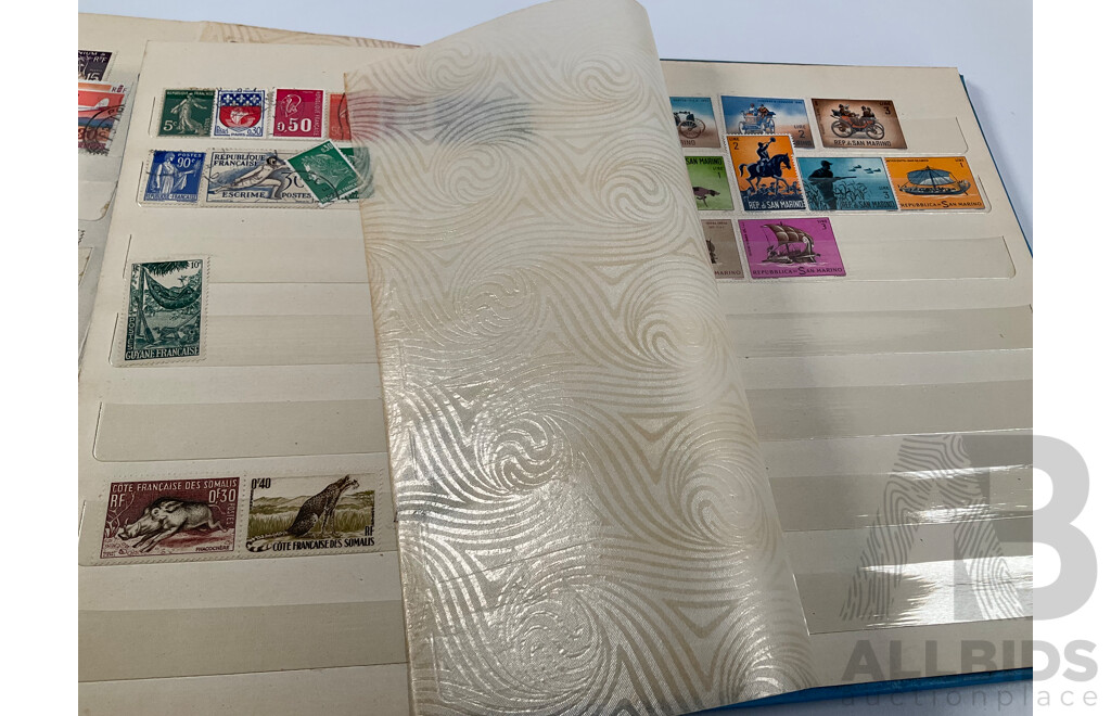 Two Albums of Vintage International Stamps Including Australian Predecimal, Canada, Great Britain, Philippines, Fiji, USA, Poland, Germany, New Zealand, Papua New Guinea and More