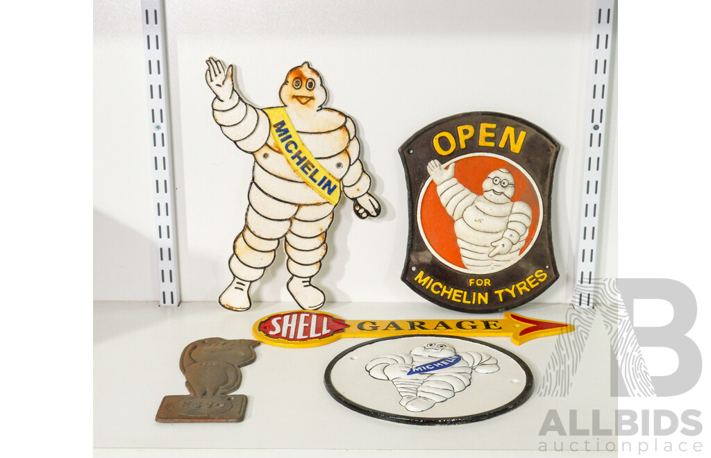 Collection of 5 Cast Iron Signs Including Michelin, Shell, and Esso