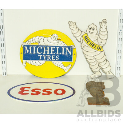 Collection of Cast Iron Wall Mounts Including Two Esso and Two Michelin Tires