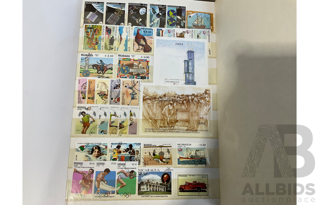 Two Albums of Antique and Vintage International Mint and Cancelled Stamps Including Zanzibar Nigeria, Guernsey, Zimbabwe, Zaire, Uruguay, Paraguay, Mexico, Brazil, Guyana, Colombia and More