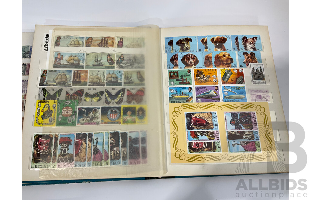 Three Albums of Vintage Cancelled and Mint Stamps Including Australia, Liberia, Mongolia, Thailand, Spain