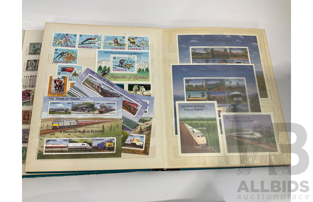 Three Albums of Vintage Cancelled and Mint Stamps Including Australia, Liberia, Mongolia, Thailand, Spain