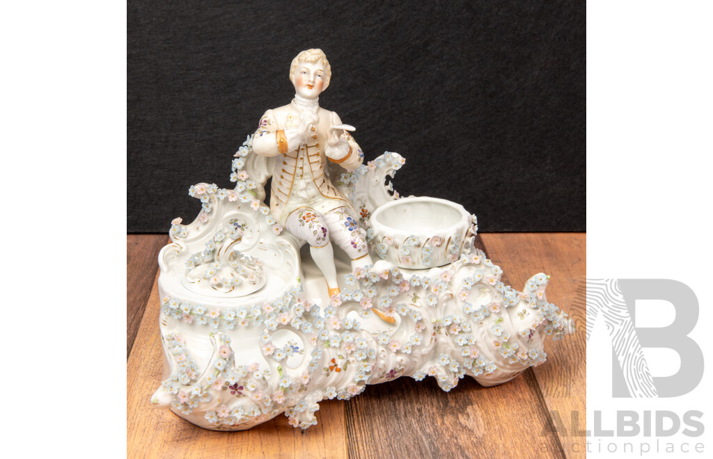 a Porcelain Inkwell with Seated Gentleman and Applied Floral Decoration, Saxe Mark, C.1900