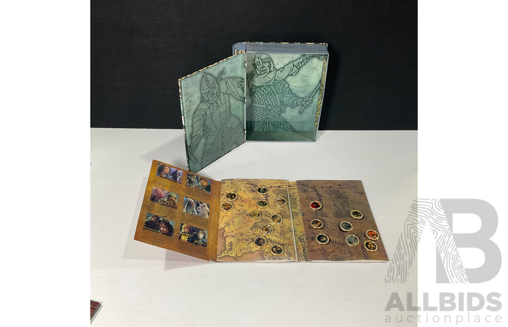 Collection of Lord of the Rings Paraphernalia in Original Packaging Including Pin Collection, Cards, Clock, Sticker Collection Book, Tin Container and More