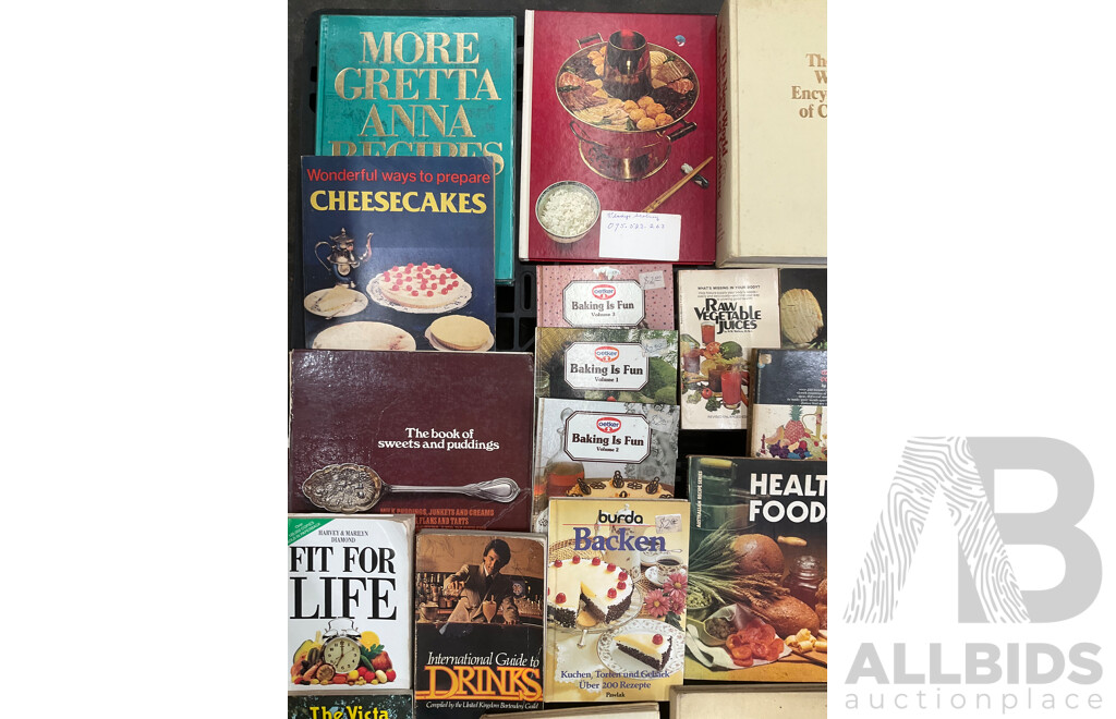 Collection of Vintage Cookbooks Spanning Various Cuisines and Baking Styles