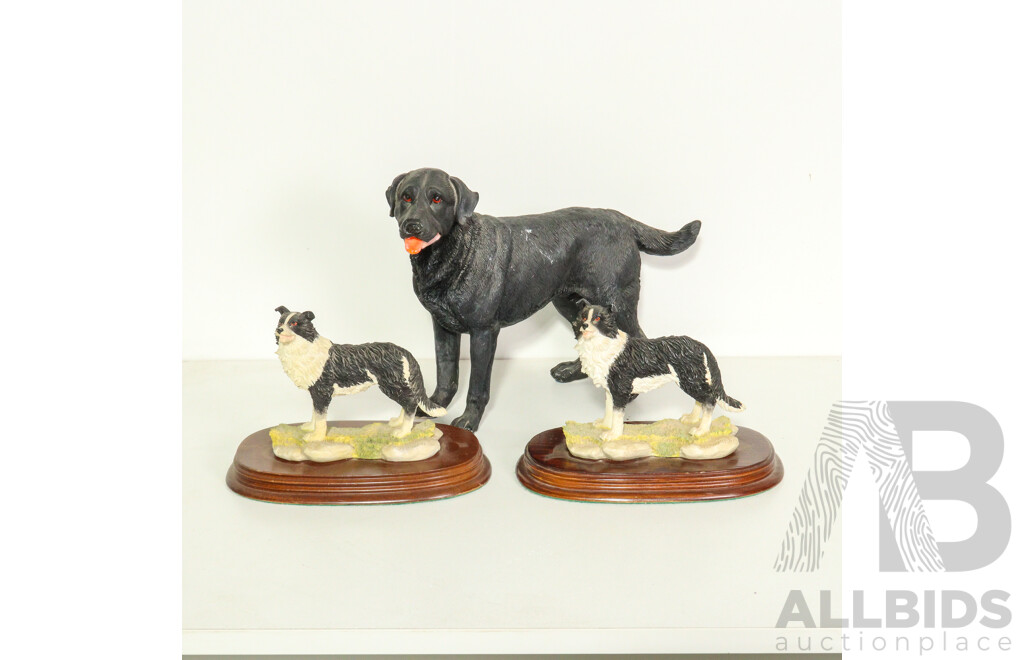 Three Resin Dog Figurines: Border Collies on Wooden Bases and a Labrador