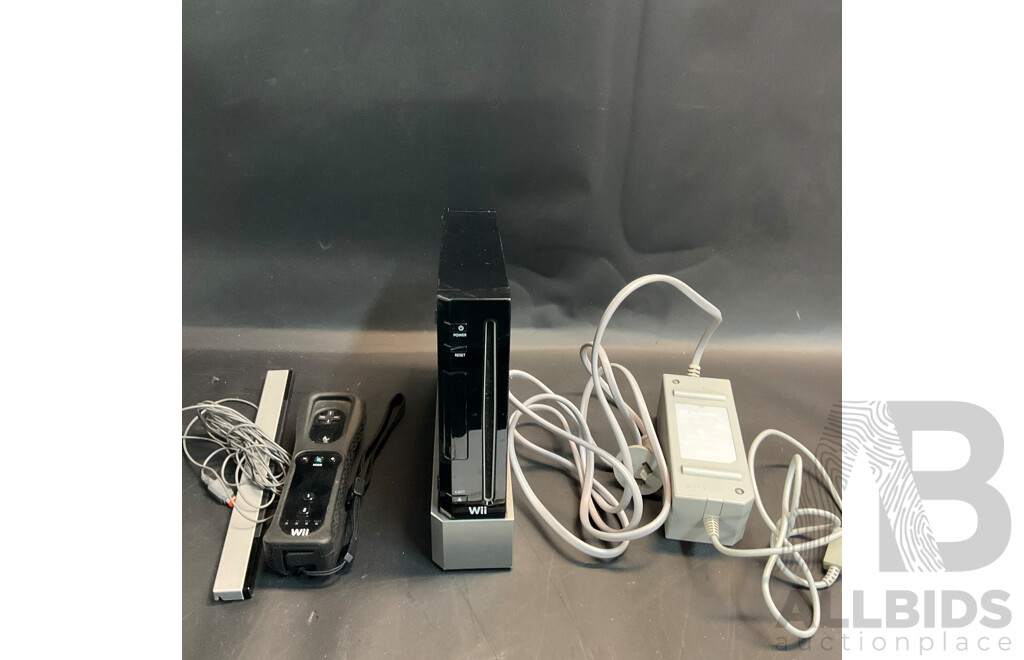 Nintendo Wii Console with Wii Fit Plus and MarioKart Game/Steering Wheel & Sports Pact 8 in 1 for Wii Sports Resort