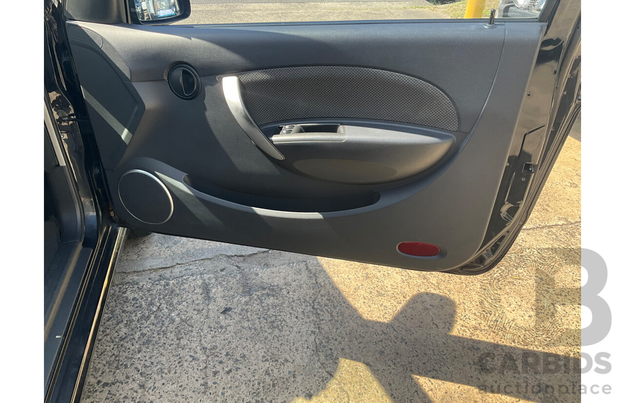 2/2010 Holden Barina TK MY10 3d Hatchback Black 1.6L