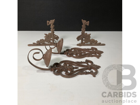 Collection of Four Wall Mounted Cast Iron Candle Holders and Decorative Brackets