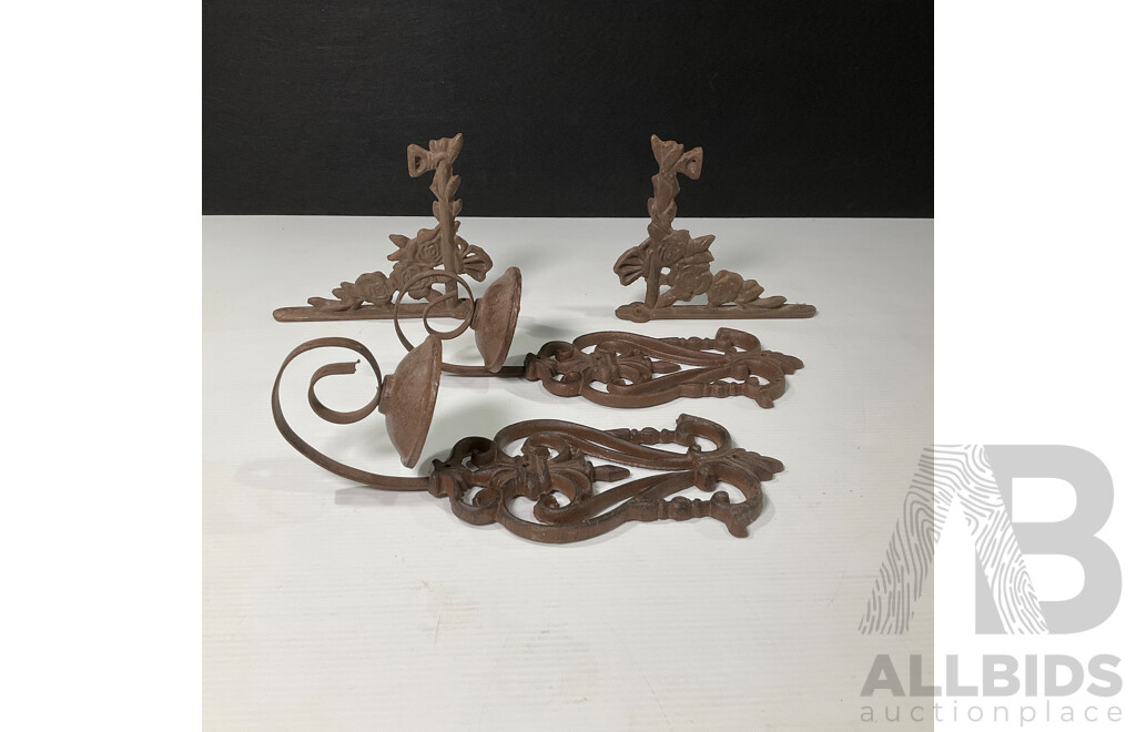 Collection of Four Wall Mounted Cast Iron Candle Holders and Decorative Brackets