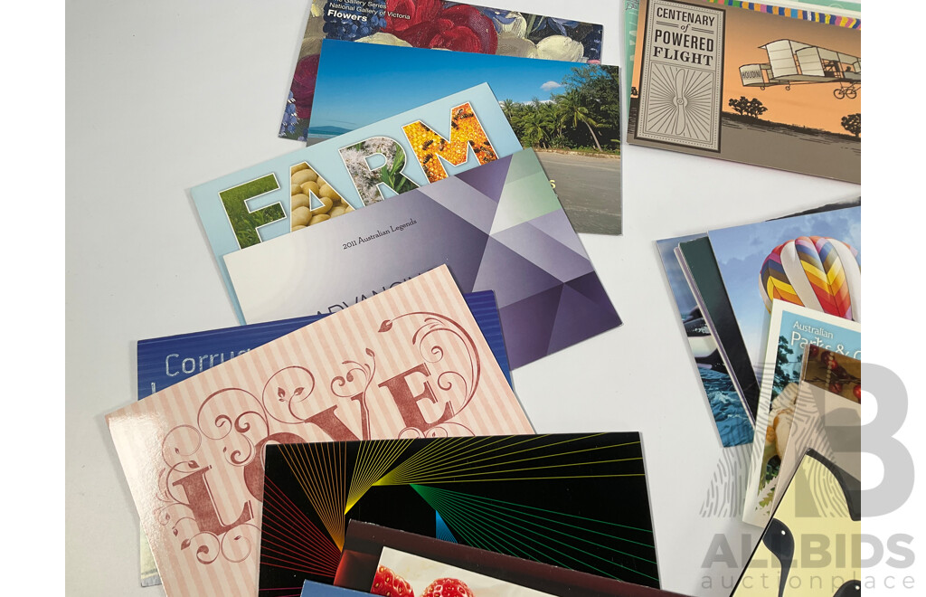 Fifty Six Australian Mint Stamp Packs Including Queensland 150 Years, Stargazing, Species at Risk, with Love, Beijing 2008, Gorgeous Australia, Living Green, Australian Commonwealth Coinage and More Face Value Approximately $217