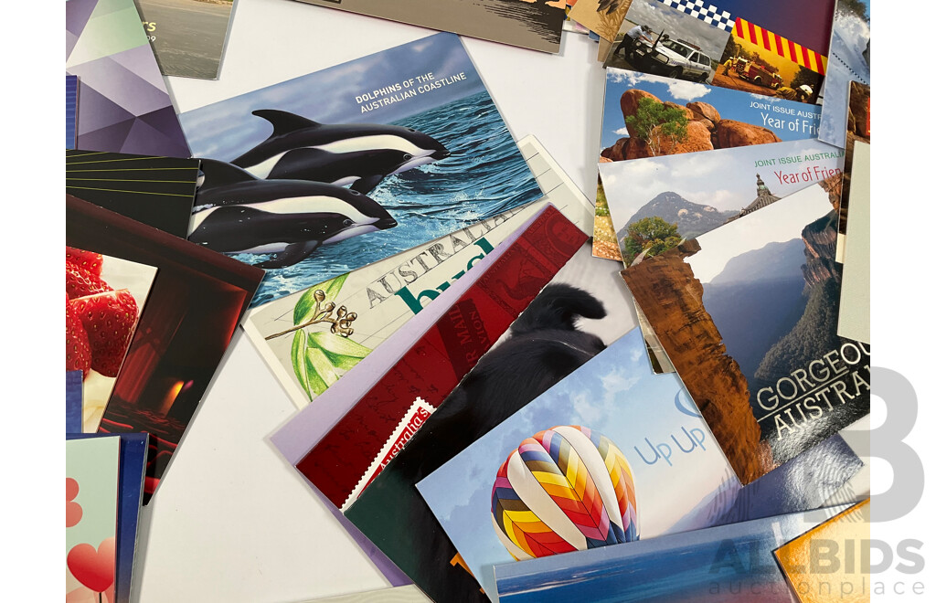 Fifty Six Australian Mint Stamp Packs Including Queensland 150 Years, Stargazing, Species at Risk, with Love, Beijing 2008, Gorgeous Australia, Living Green, Australian Commonwealth Coinage and More Face Value Approximately $217